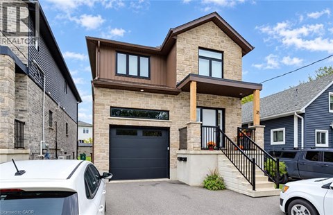 A modern house with a garage and a car parked in front.
