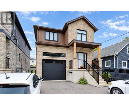 A modern house with a garage is for sale.