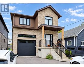 A modern house with a garage is for sale.
