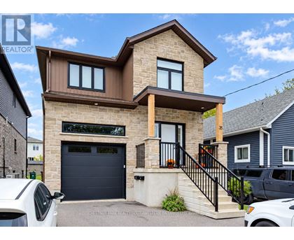 A modern house with a garage is for sale.