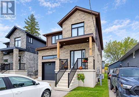 A modern house with a white car parked in front.