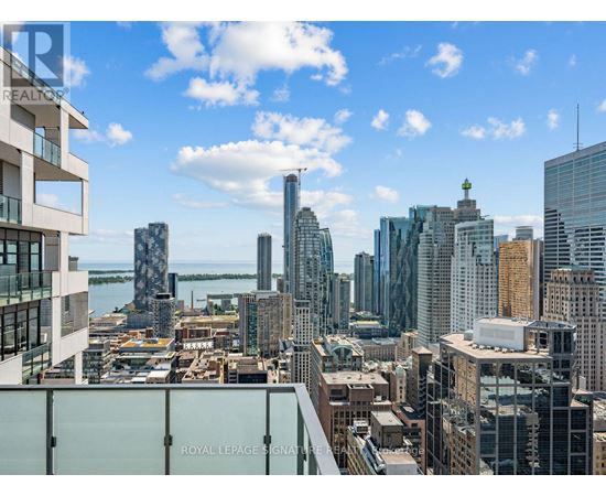 A cityscape with a clear sky and a building with the words "Royal LePage Signature" on it.