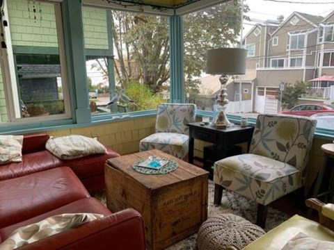 A living room with a red couch, a wooden coffee table, and a lamp.