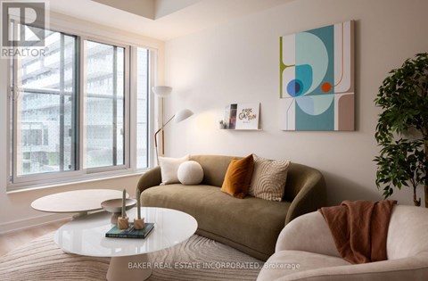 A living room with a couch, a table, and a painting on the wall.