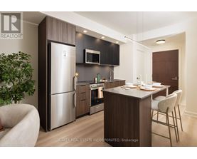 A modern kitchen with a dining table and chairs.