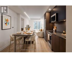 A modern kitchen with a dining table set for two.