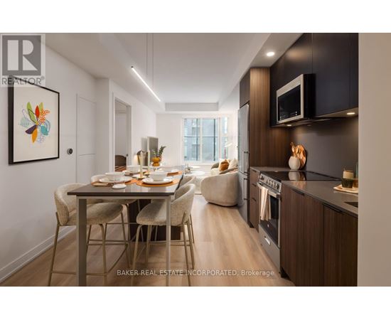 A modern kitchen with a dining table set for two.