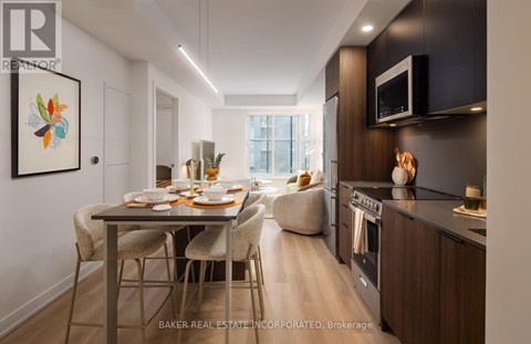 A modern kitchen with a dining table set for two.