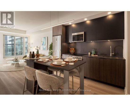 A modern kitchen with a dining table set for two.