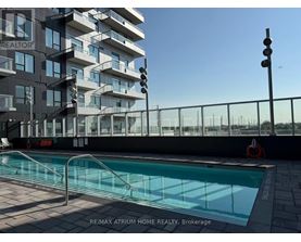 A pool is located outside of a building with the words RE/MAX Atrum Home Realty, Brokerage written on the ground.
