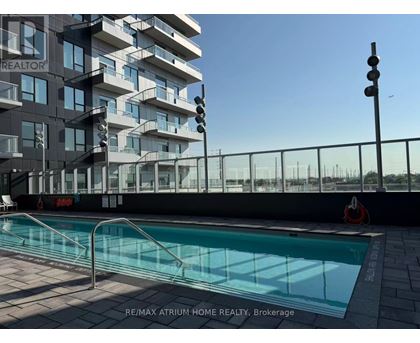 A pool is located outside of a building with the words RE/MAX Atrum Home Realty, Brokerage written on the ground.