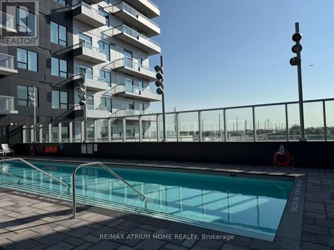 A pool is located outside of a building with the words RE/MAX Atrum Home Realty, Brokerage written on the ground.