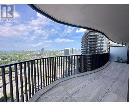 A balcony with a railing overlooking a cityscape.