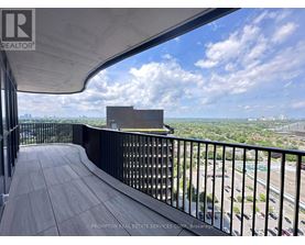 A balcony with a view of the cityscape and a building in the distance.