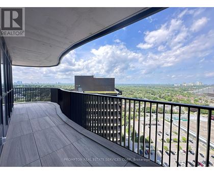 A balcony with a view of the cityscape and a building in the distance.