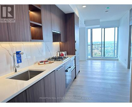 A kitchen with a stove top oven and a sink.