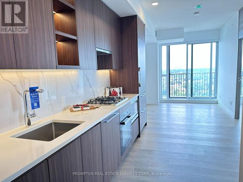 A kitchen with a stove top oven and a sink.