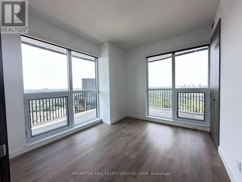 A room with a balcony and sliding glass doors.