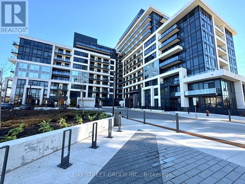 A modern multi-story building with glass windows and a sign that reads "REALTOR".