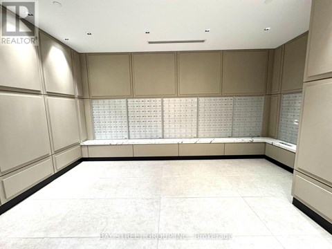 A large, empty room with a long table and a wall of windows.