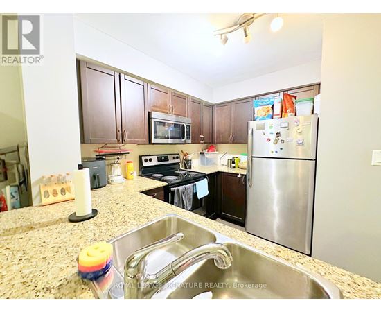 A kitchen with granite countertops and stainless steel appliances.