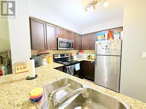 A kitchen with granite countertops and stainless steel appliances.