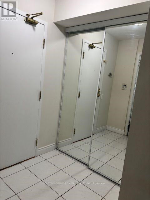 A white door with a mirror on the right side.