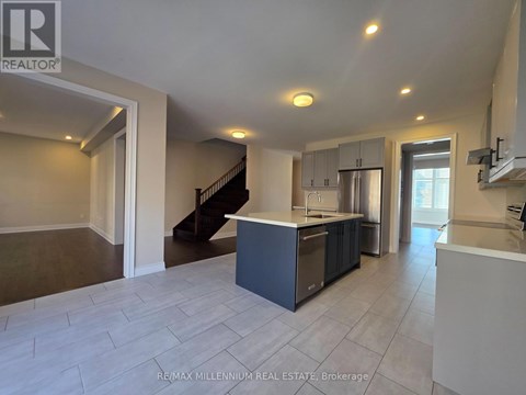 A spacious kitchen with a recessed lighting ceiling.
