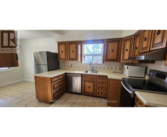 A kitchen with wooden cabinets and a refrigerator.