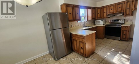 A kitchen with a refrigerator, stove, and oven.