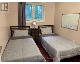 Two twin beds in a room with a whiteboard on the wall.