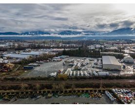 An aerial view of a parking lot with a mountain range in the background.