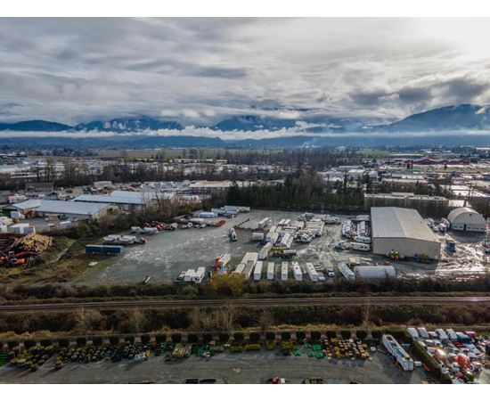 An aerial view of a parking lot with a mountain range in the background.