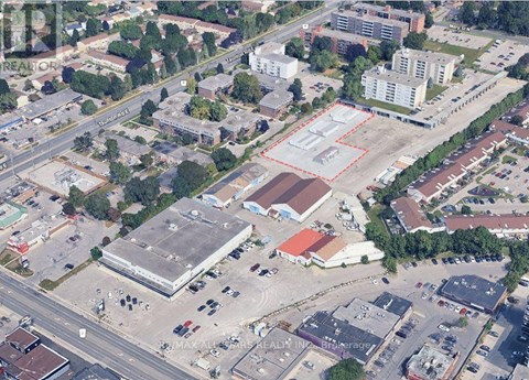 An aerial view of a city with buildings, roads, and trees.