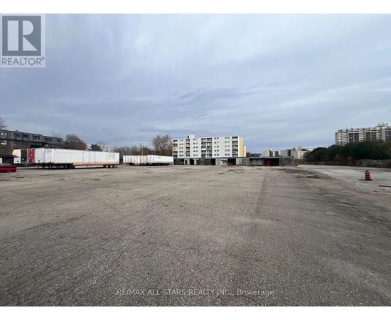 A large, empty parking lot with a building in the background.