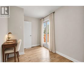 A room with a desk and chair in it.