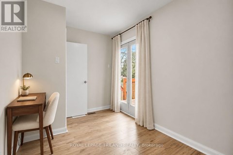 A room with a desk and chair in it.