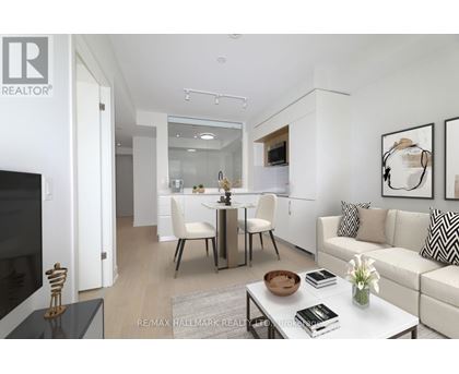 A modern living room with a white sofa, a glass table, and a television.