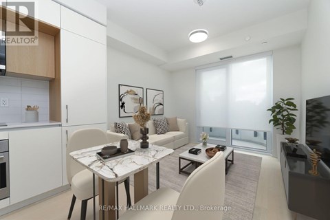 A modern living room with a dining table and chairs.