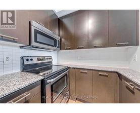 A kitchen with a stove top oven and microwave above it.