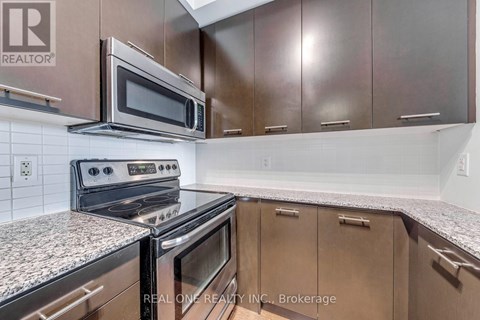 A kitchen with a stove top oven and microwave above it.