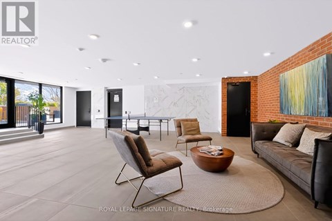 A living room with a couch, chairs, and a coffee table.