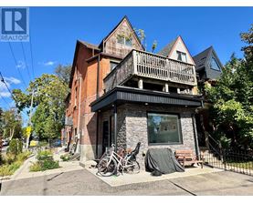 A house with a balcony and a bicycle parked in front.