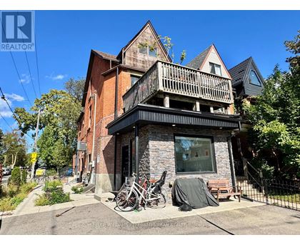 A house with a balcony and a bicycle parked in front.