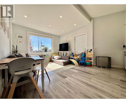 A living room with a white chair and a white table.