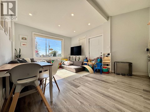 A living room with a white chair and a white table.