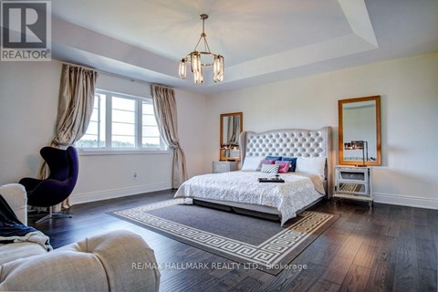 A bedroom with a large bed and a chair.