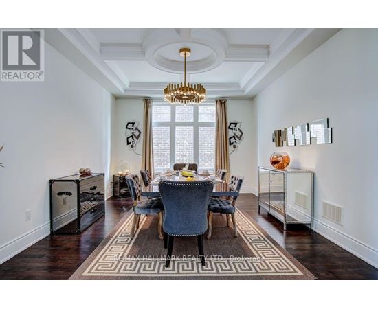 A dining room with a table set for six and a chandelier hanging from the ceiling.