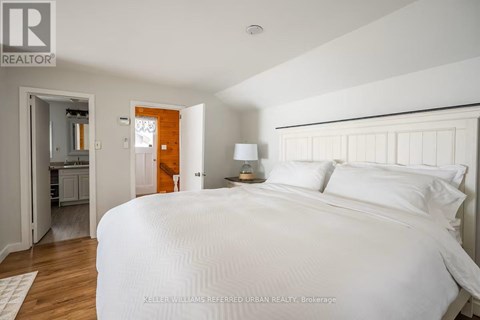 A bedroom with a large bed and a small closet.