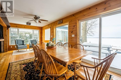 A dining room with a wooden table and chairs.